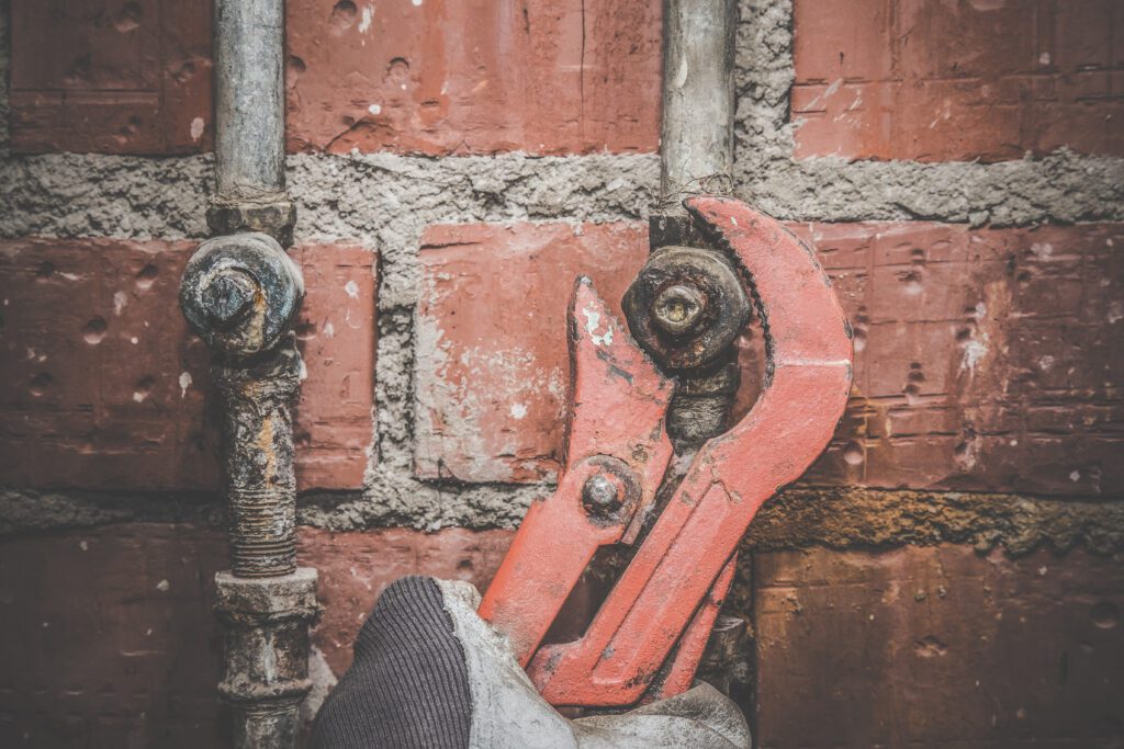 Licensed plumber repairing pipes in Mesa AZ home